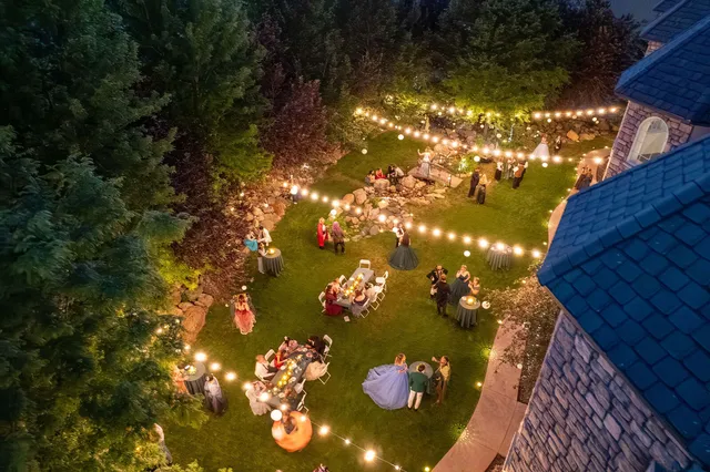 Aerial view of the Waterfall Grounds aglow with fairy lights at dusk